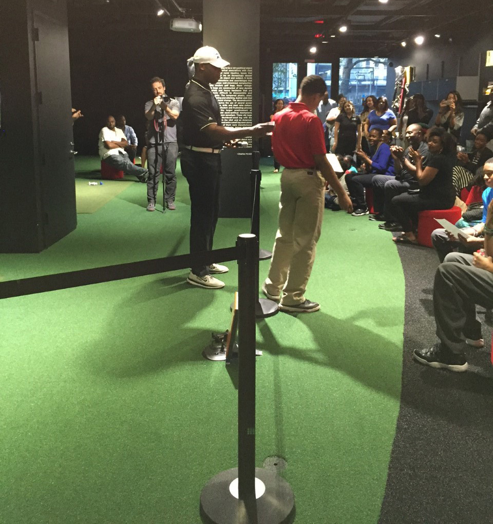 Teaching Professional Randy Taylor giving the Pete Brown MVP Award to Antonio Cortorreal