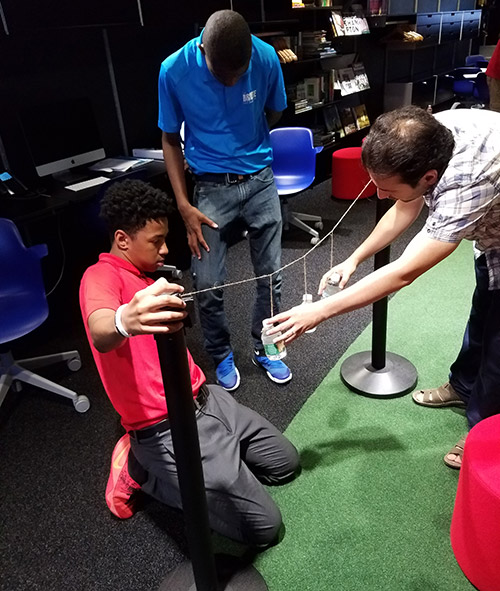 Professor Pouyan Ghaemi worked on the water-bottle pendulums for the particle demonstration.