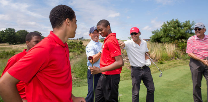 Tariq Washington, center, hit the shot of the day during our par-3 tournament at The Bridge last summer