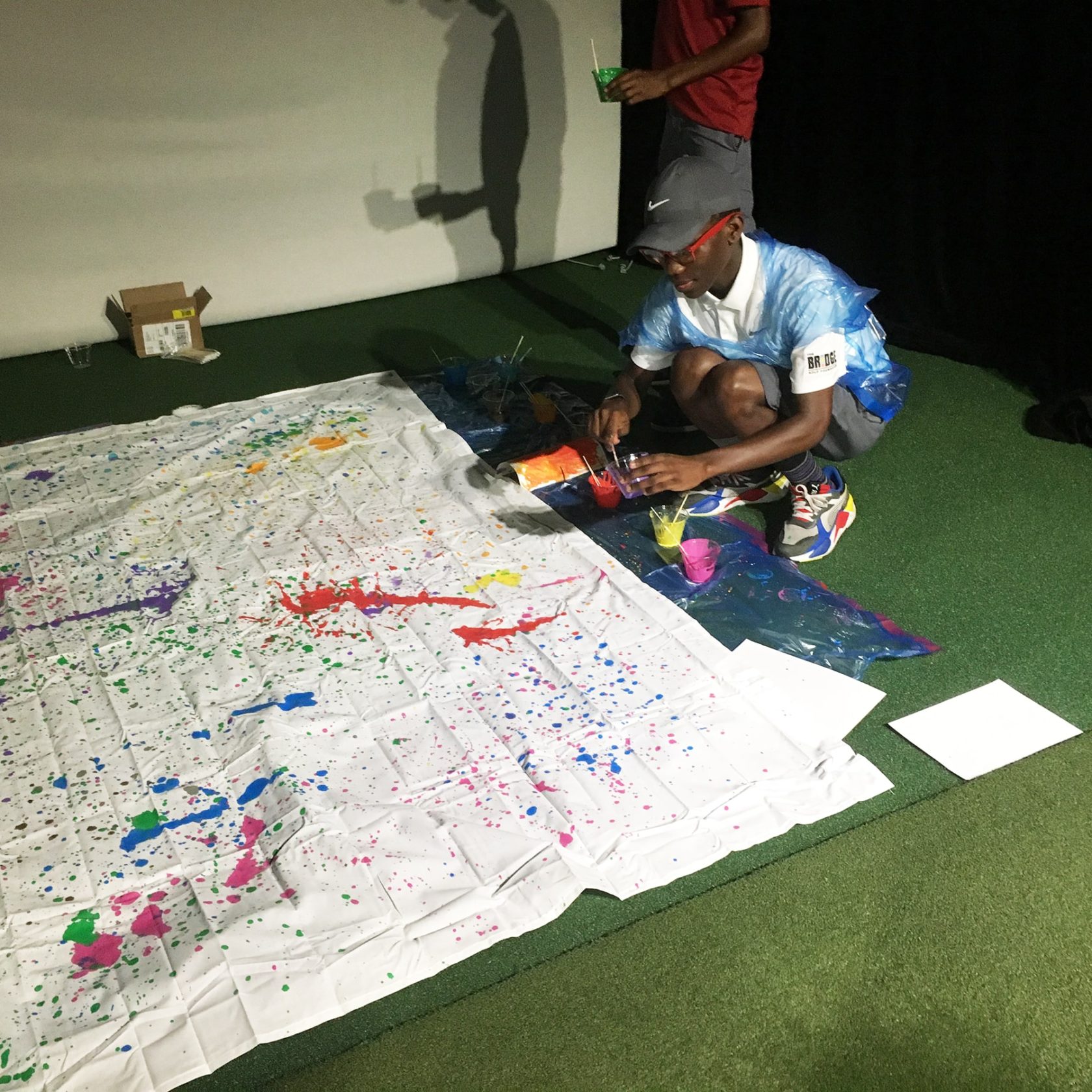 Elijah Opoku working on our Jackson Pollock-inspired group painting.