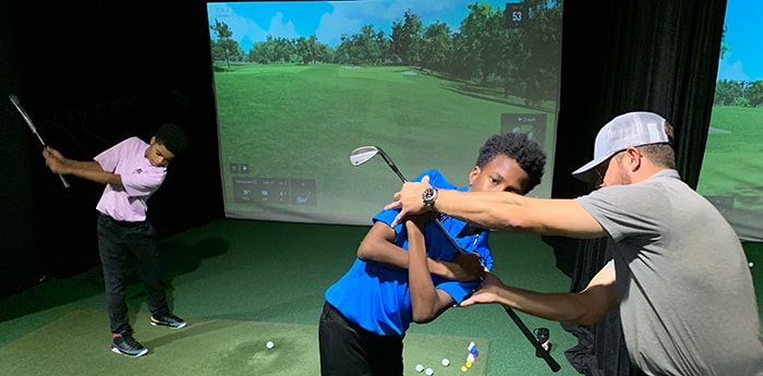 pro giving junior lessons at The Bridge Golf Learning Center